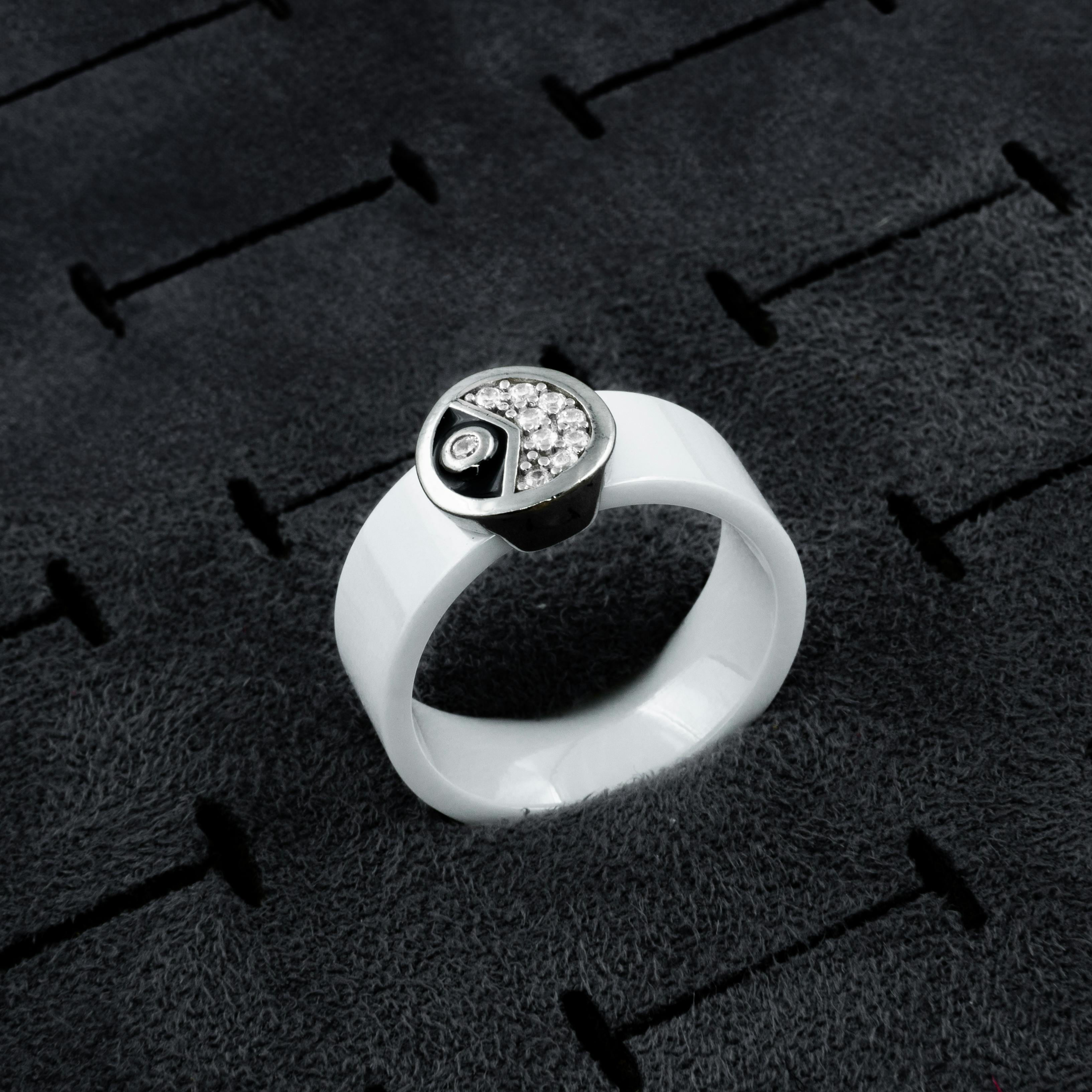 Stylish white ceramic ring featuring rhinestones on a textured surface for a modern look.