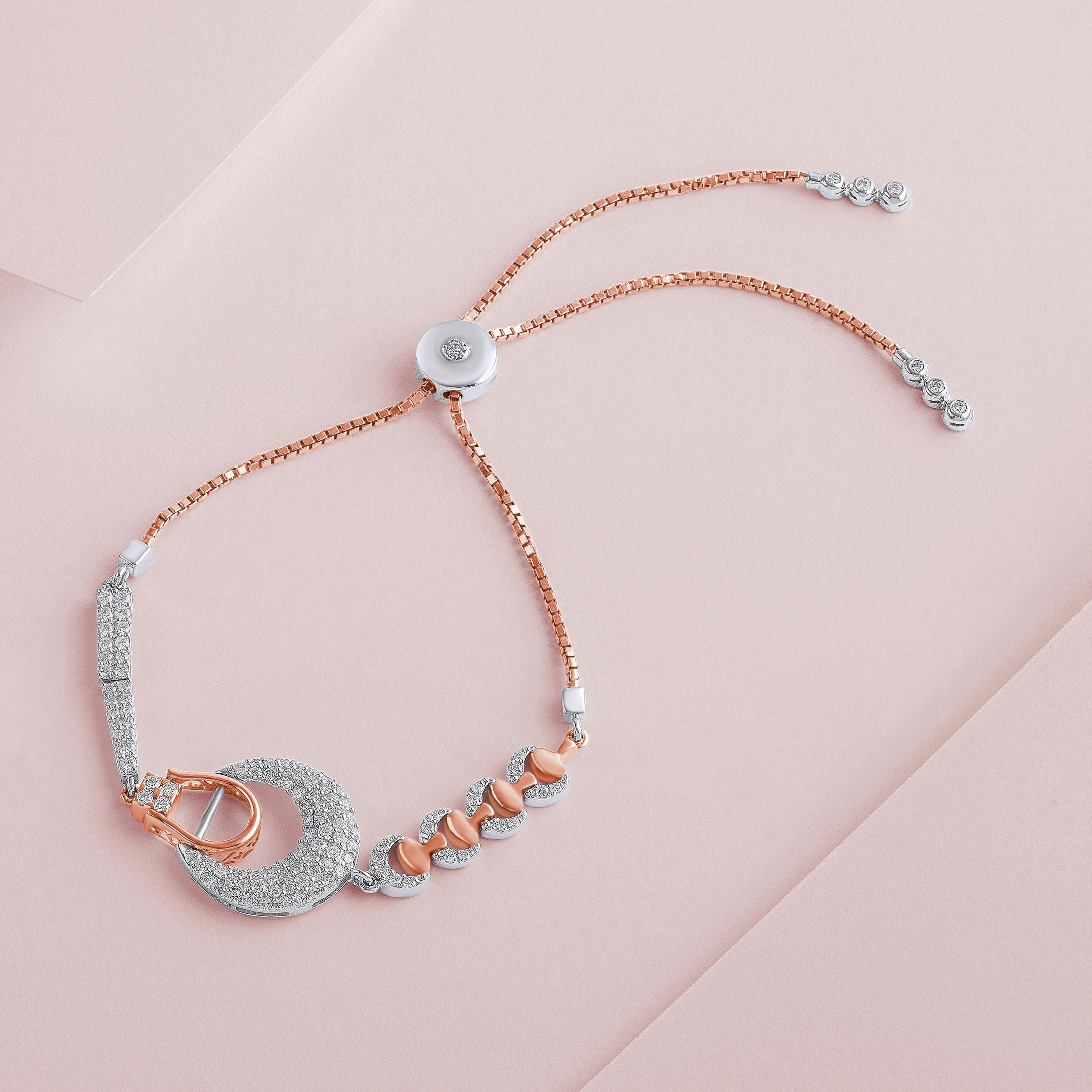 Close-up of a delicate rose gold and silver bracelet on a soft pastel background, showcasing intricate jewelry design.